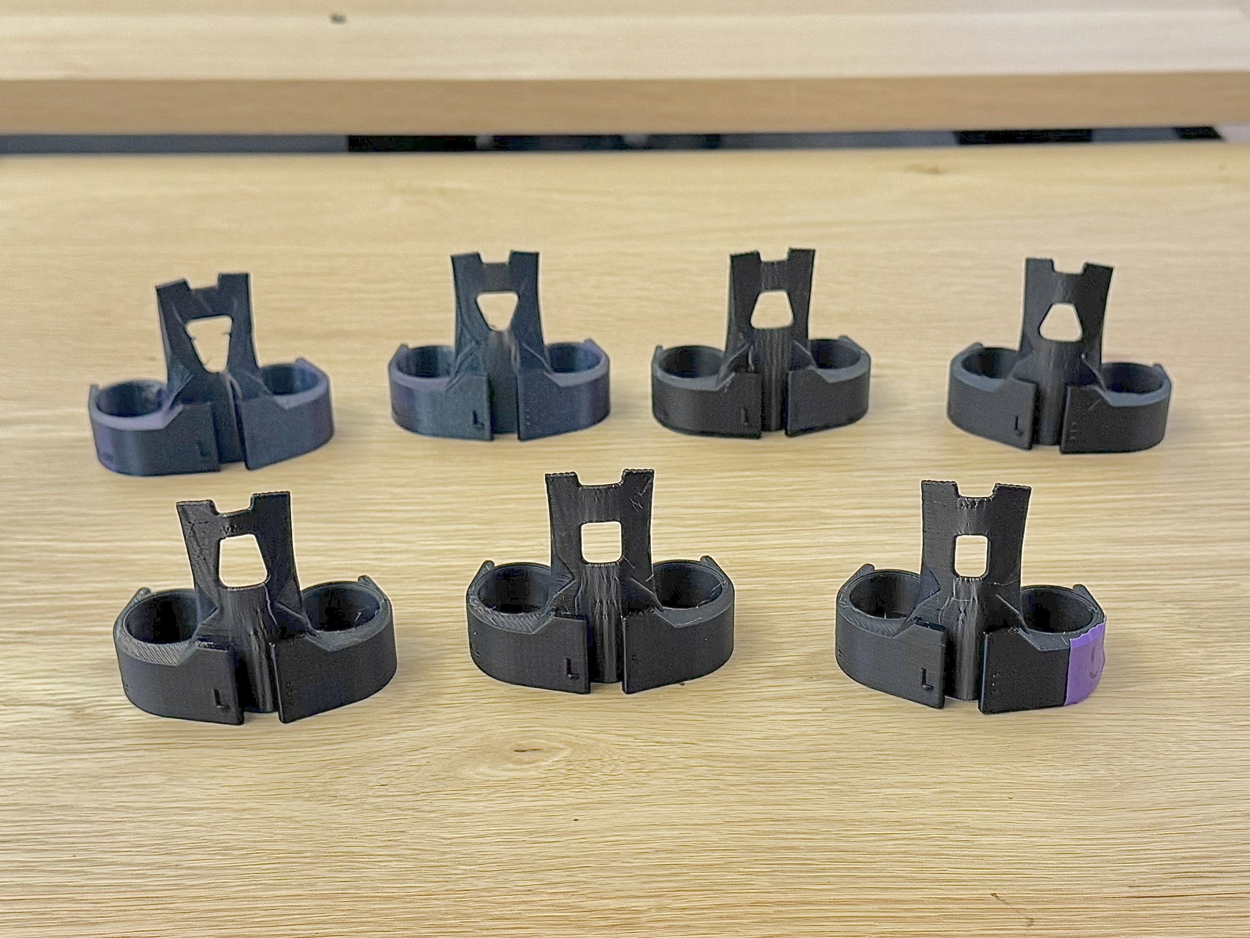 Two rows of 3D printed eating tools with different hole shapes
