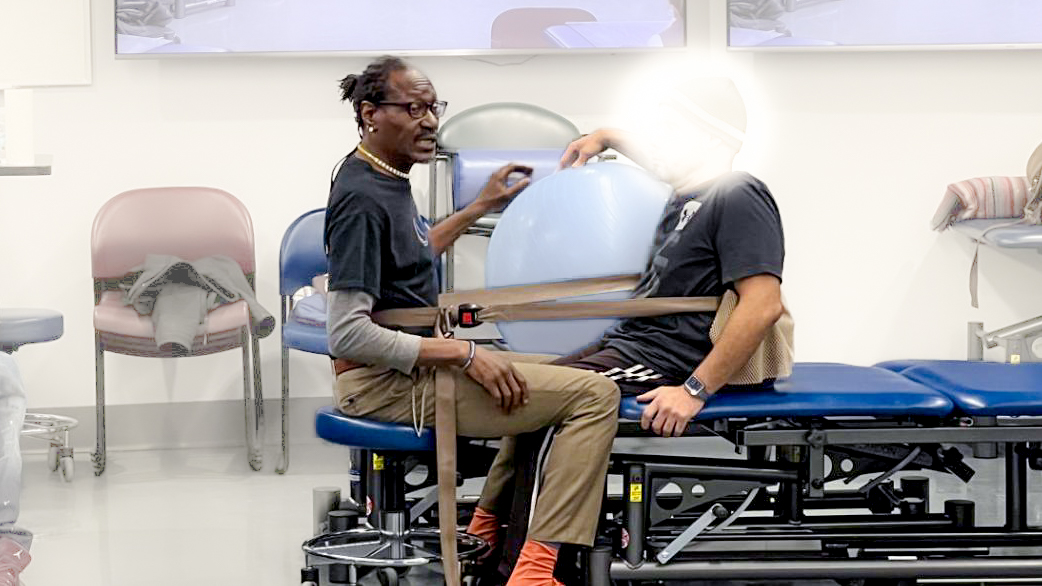 Lawrence on the left, patient on the right, a belt wrapped around them